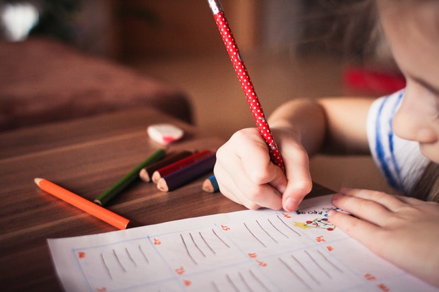 Child Writing on Paper
