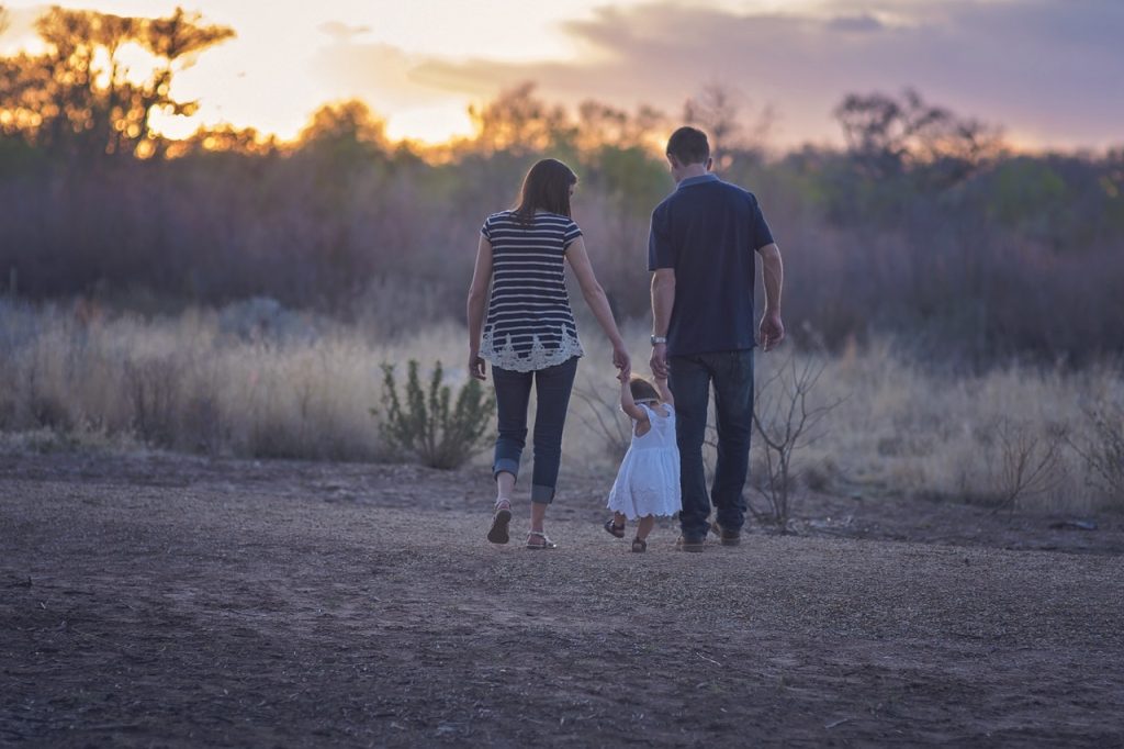 Mom and Dad and Child walking in a field