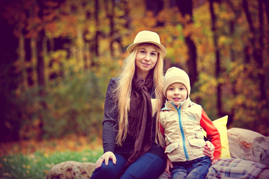 Mother and Child Sitting in an Autumn setting